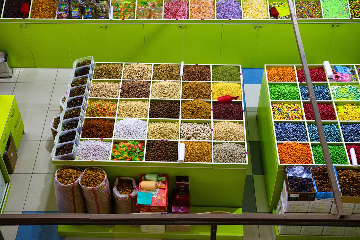 Marktkraam met bakken vol noten, zaden en snoep.
